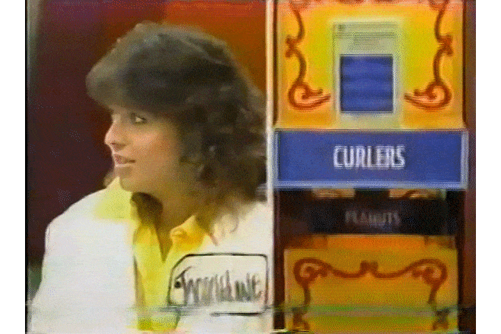 A contestant on Tom Kennedy's Price is Right watches products float down on a giant Ferris Wheel in the Pick a Pair game.