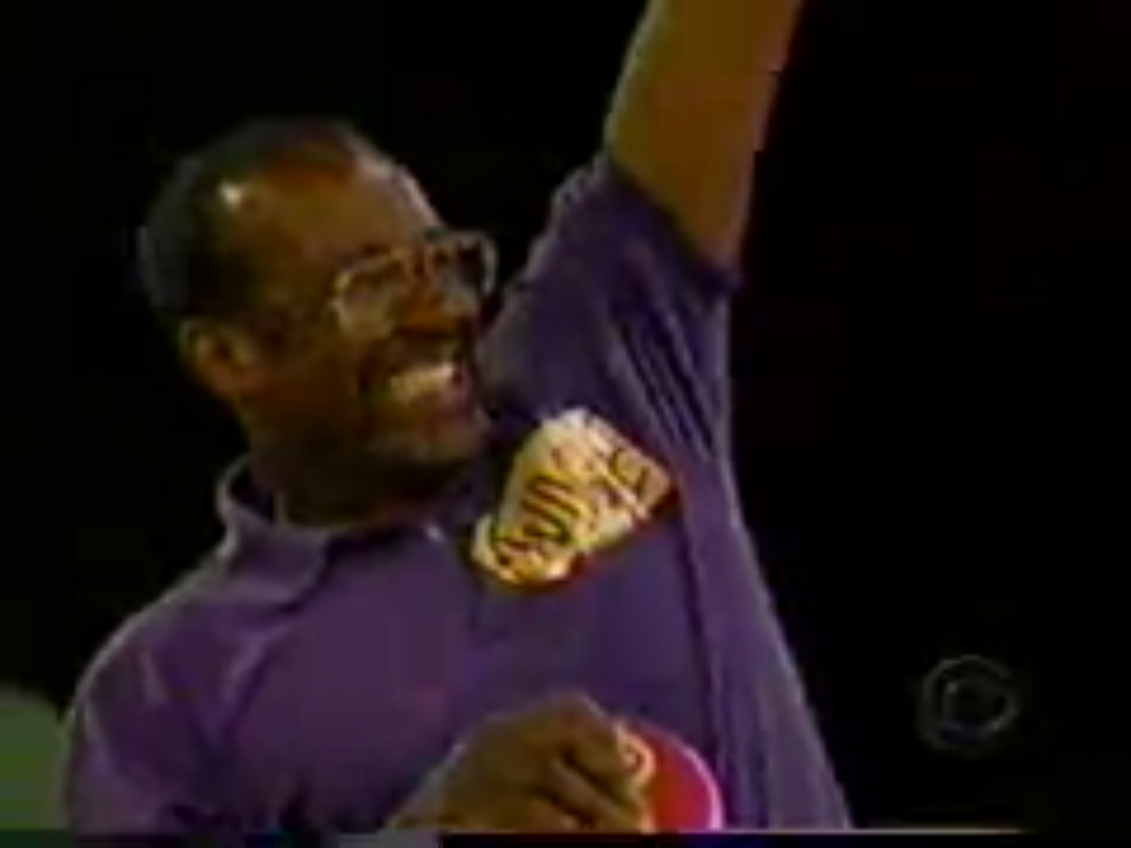 A contestant celebrates joyfully while holding a Plinko chip on the set of The Price is Right.