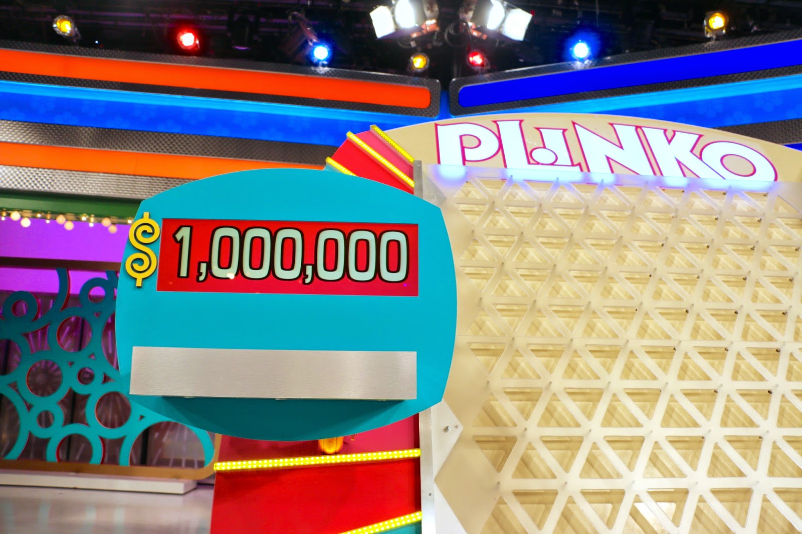 Plinko game display showing a sign with ,000,000 prize next to the Plinko board.