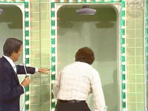 A contestant steps into a shower stall on The Price is Right and pulls a cord, and a giant novelty key labeled CAR drops down from the top of the set.