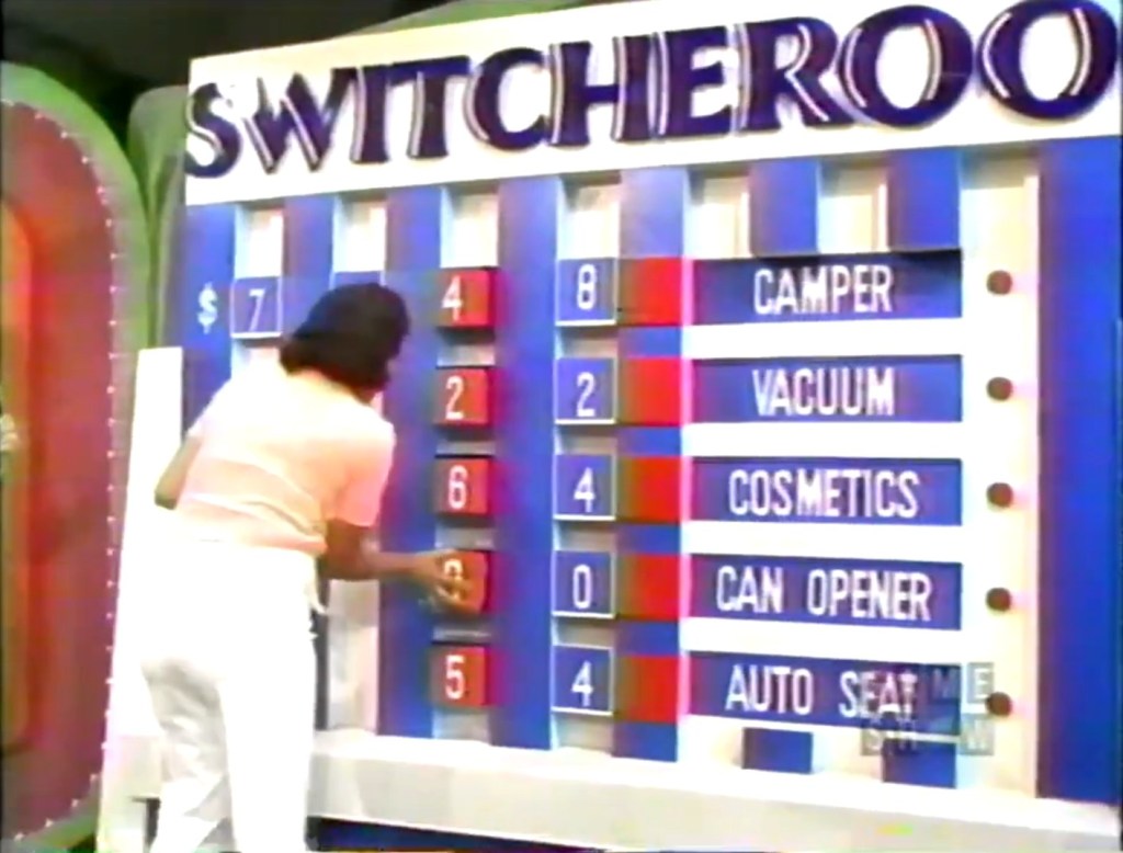 Contestant placing number blocks on the Switcheroo game board, attempting to match missing tens digits for various prizes.