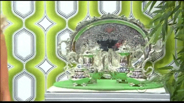 A wall containing prizes splits apart on The Price is Right to reveal a car behind it.