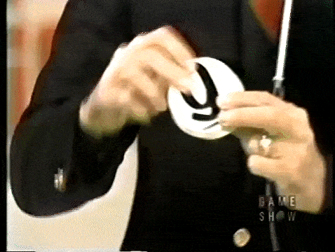 Bob Barker reveals four chips in the "Three Strikes" game before putting them in the bag.