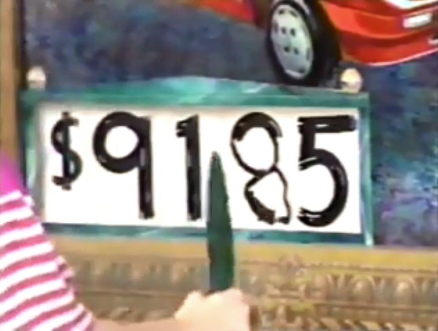 A colorful depiction of a price tag featuring the amount 85, with a person drawing the "8" in manually.