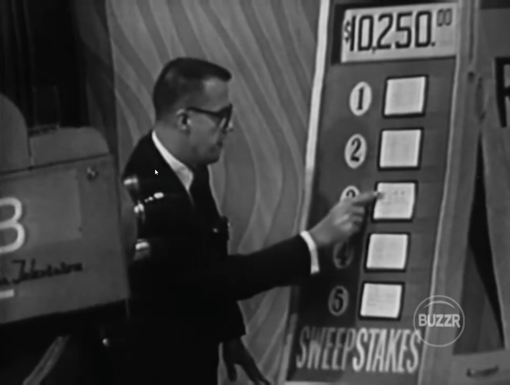 Bill Cullen gestures towards a board on The Price is Right featuring a prize total of ,250, alongside written options labeled 1 to 5, with the word 'SWEEPSTAKES' prominently displayed.