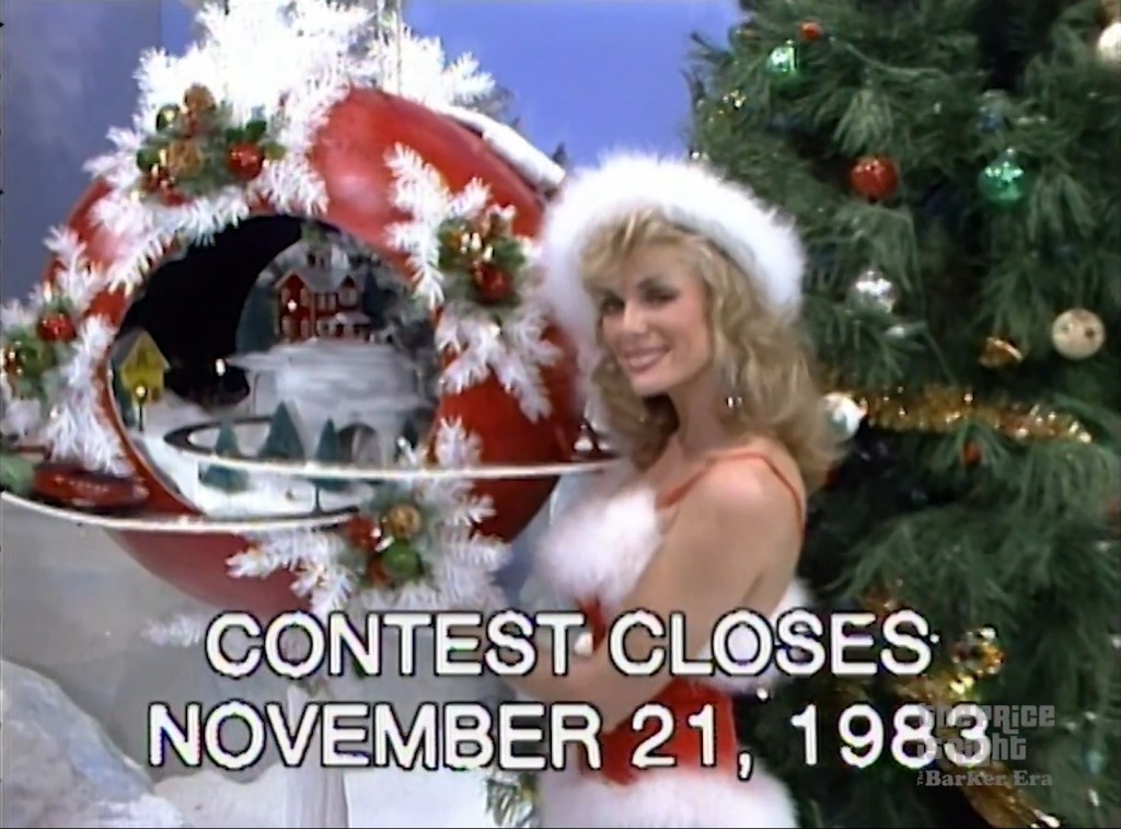 A contestant models a festive holiday decoration while promoting a contest, with a Christmas tree in the background and sign stating 'CONTEST CLOSES NOVEMBER 21, 1983'.