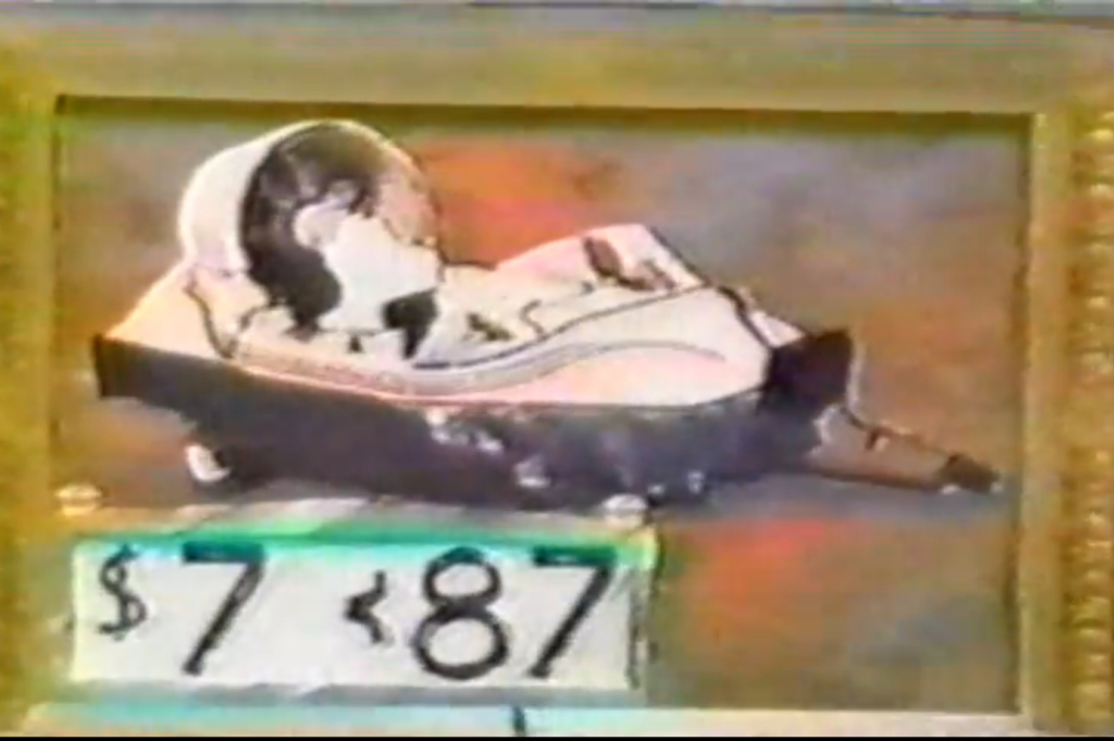 An illustration of a hovercraft, displayed within a decorative frame, featuring a price tag reading ' 87'. The second digit is incomplete and requires the contestant to fill it in as part of the Gallery Game on The Price is Right.