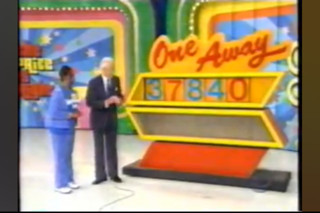 A contestant stands beside host Bob Barker in front of the 'One Away' game board displaying the incorrect price '37840'.