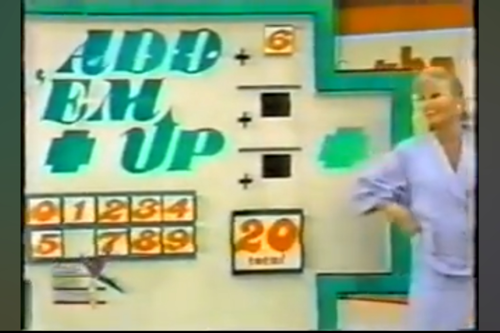 A game show set for 'Add 'Em Up' featuring a colorful board displaying numbers 0-9 and an addition equation, with a female model smiling next to it.
