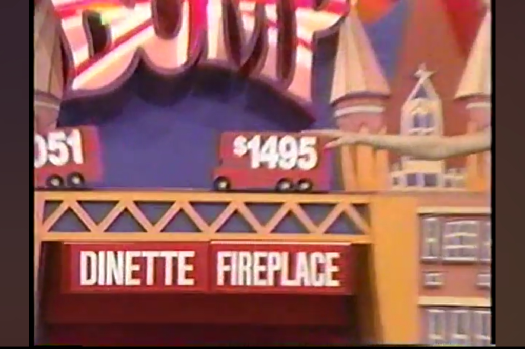 A colorful game show set featuring a large sign that says 'BUMP.' Below, two price tags, one showing 1 and the other 95, are displayed next to the words 'DINETTE' and 'FIREPLACE.'