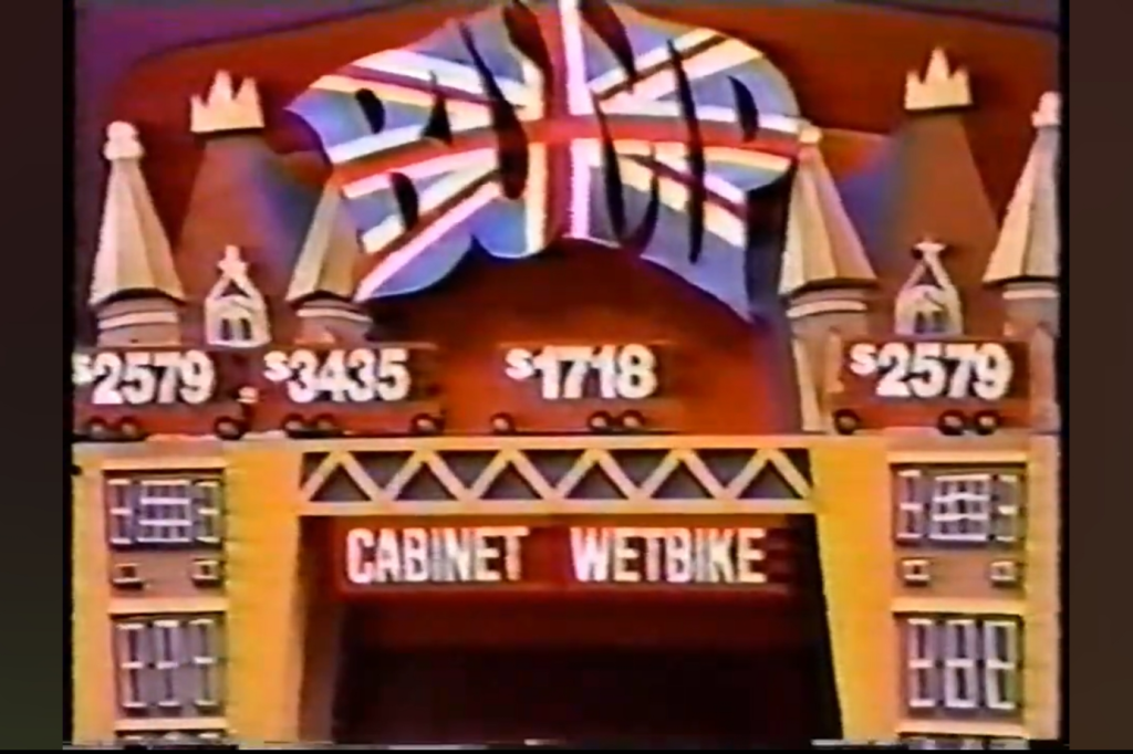 A promotional display featuring prices for items, including '79', '35', and '18', with the word 'CABINET' above 'WETBIKE' and a British flag design.