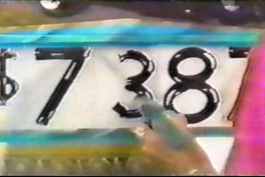 A close-up of a person's hand painting a number "3" in the price, completing a large, stylized number '7387' on a colorful background.