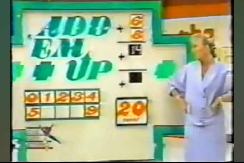 A game show display titled 'Add 'Em Up' featuring numbers and arithmetic operations on a colorful set, with a female host in a light blue outfit.