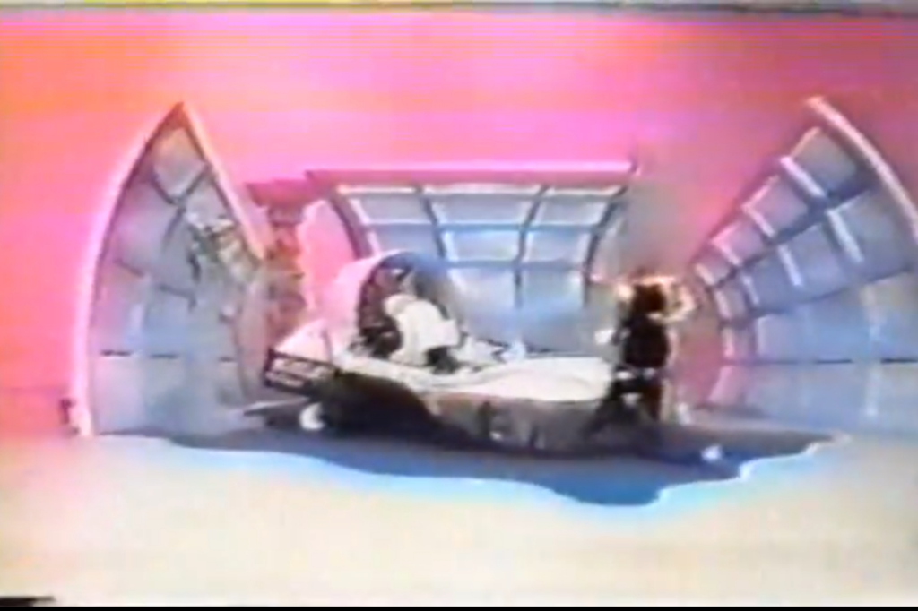 A model on The Price is RIght shows off a hoverjet, offered as a prize.