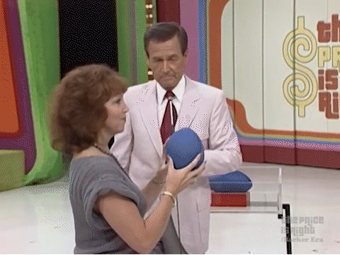 A contestant poorly throwing a football toward a cardboard target of a receiver playing On the Nose on The Price is Right.