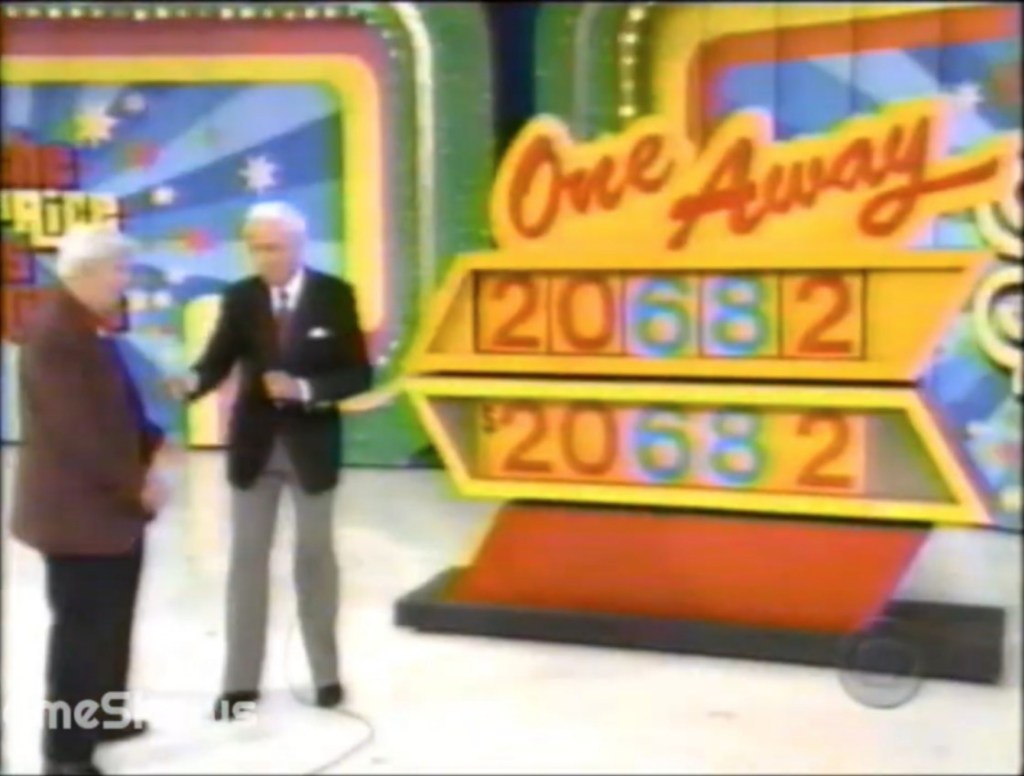 A scene from 'One Away' featuring a contestant and host Bob Barker, with the game board displaying the incorrect car price 20682.
