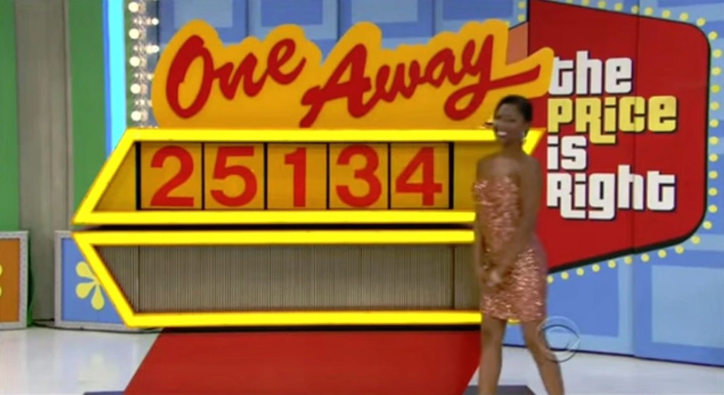 A model stands next to the 'One Away' game display on 'The Price is Right', with the incorrect price of ,134 shown on the screen.