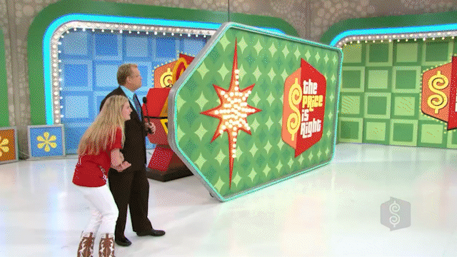 A camera zooms into a green door revealing a car, as a contestant excitedly falls to the floor with excitement.