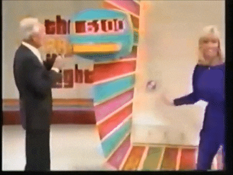 Contestant Jennifer begins jumping up and down atop the Plinko board trying to knock a stuck chip loose.