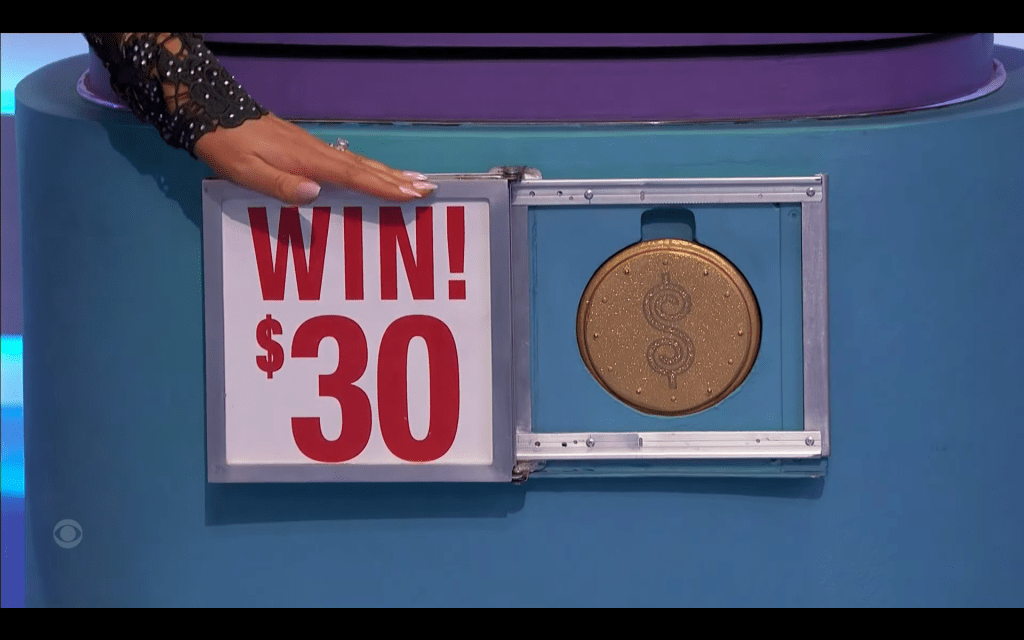 A close-up of a game display with a 'WIN!' sign and a golden Plinko Chip showing the amount of .