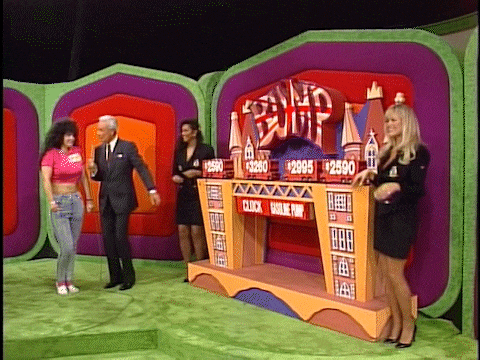 A scene from The Price is Right featuring Bob Barker bouncing alongside contestant Marilyn, with Kathleen Bradley and Dian Parkinson joining in on aa colorful stage backdrop and a large game board displaying the word 'BUMP'.